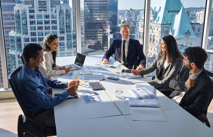 International happy professional business team consulting at group meeting. Multicultural busy coworkers working together in teamwork discussing project managing work plan in office board room.